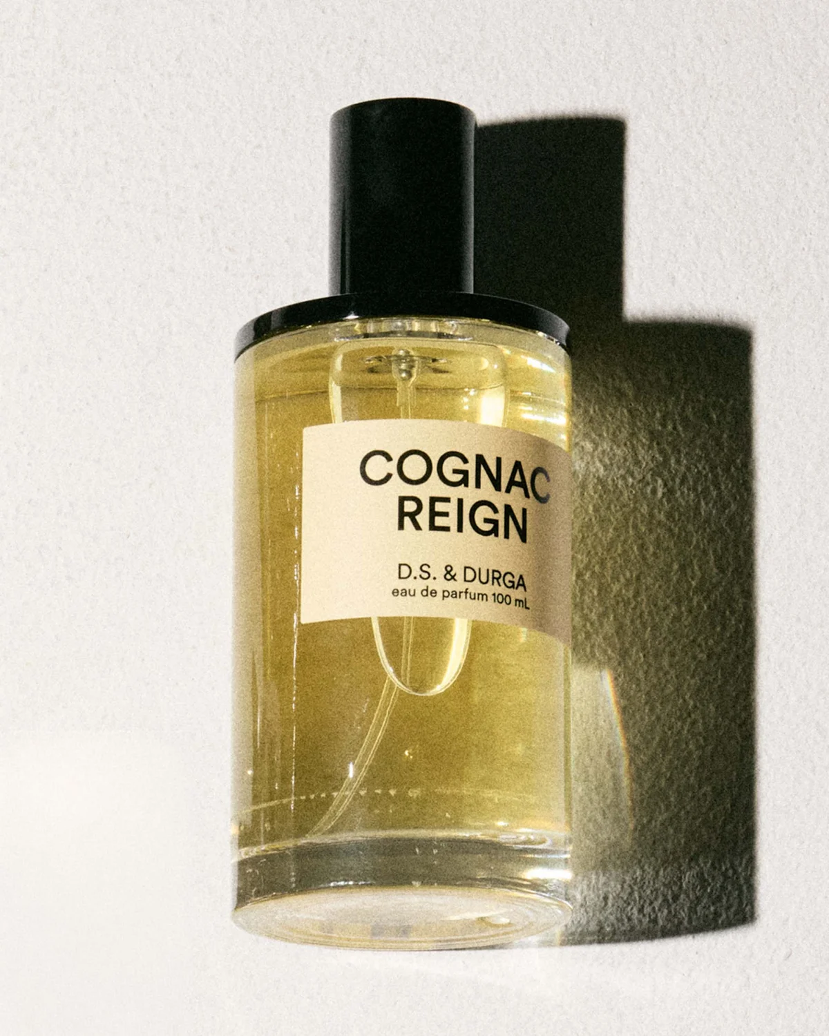 Cognac Reign perfume bottle by D.S. & Durga, featuring a sleek design and golden liquid inside. Cognac Reign perfume bottle by D.S. & Durga, featuring a sleek design and golden liquid inside.