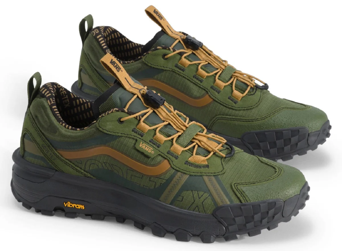 Green and black Vans shoes with yellow accents and a textured sole, designed for outdoor activities. Green and black Vans shoes with yellow accents and a textured sole, designed for outdoor activities.