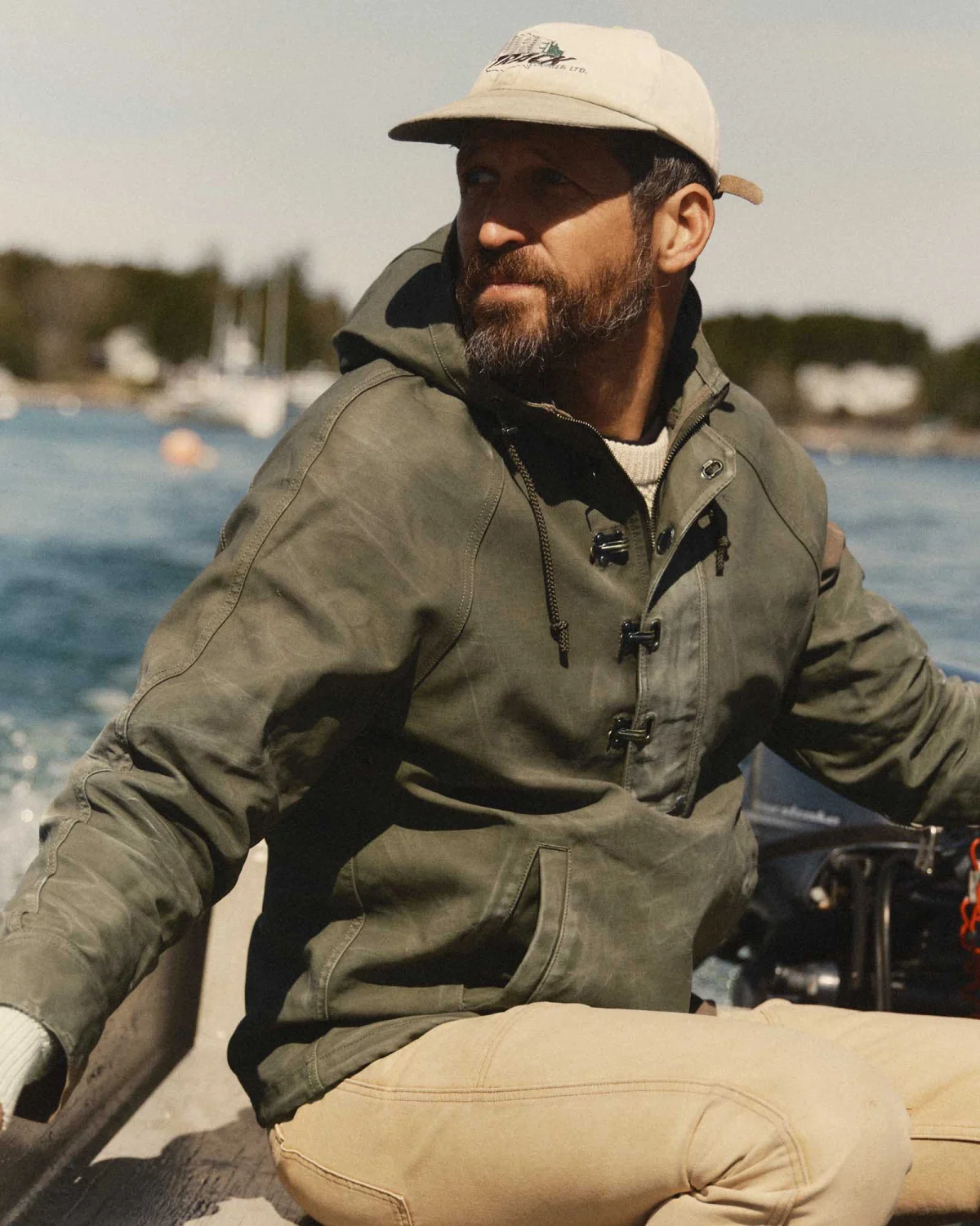 Man wearing an anorak on a boat