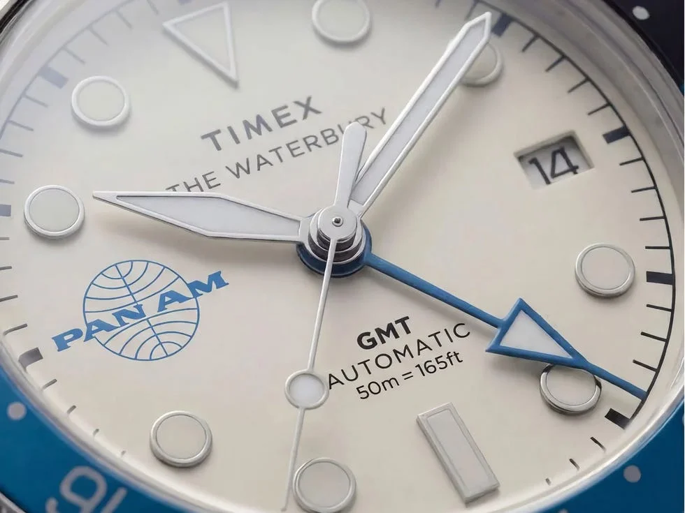 close up of Timex The Waterbury watch with Pan Am logo and date displayed.