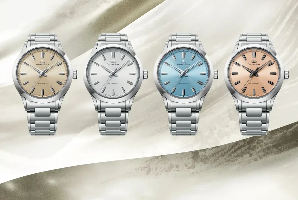 four orient star watches in silver, cream, blue, and rose gold.
