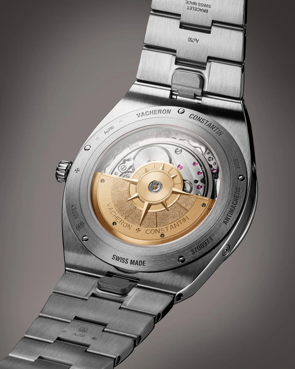 luxury watch with open case back showing intricate movement.